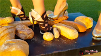 Two girls crushing bread in high heels.