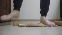 Girl crushing bread with barefeet